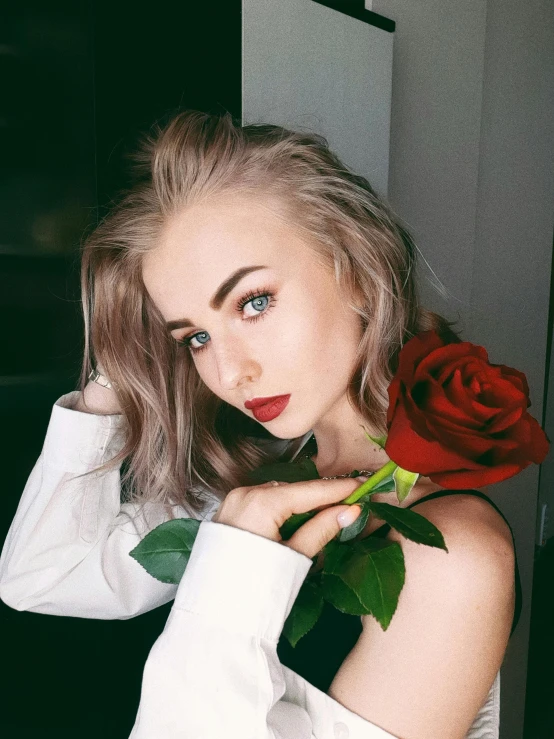 a woman in a white shirt holding a red rose, a colorized photo, inspired by Elsa Bleda, trending on unsplash, portrait of kim petras, better known as amouranth, discord profile picture, red and grey only