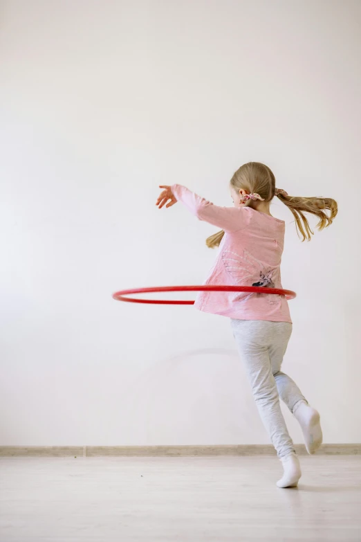 a little girl playing with a hula hoop, by Nina Hamnett, arabesque, indoor, promo image, round format, gen z