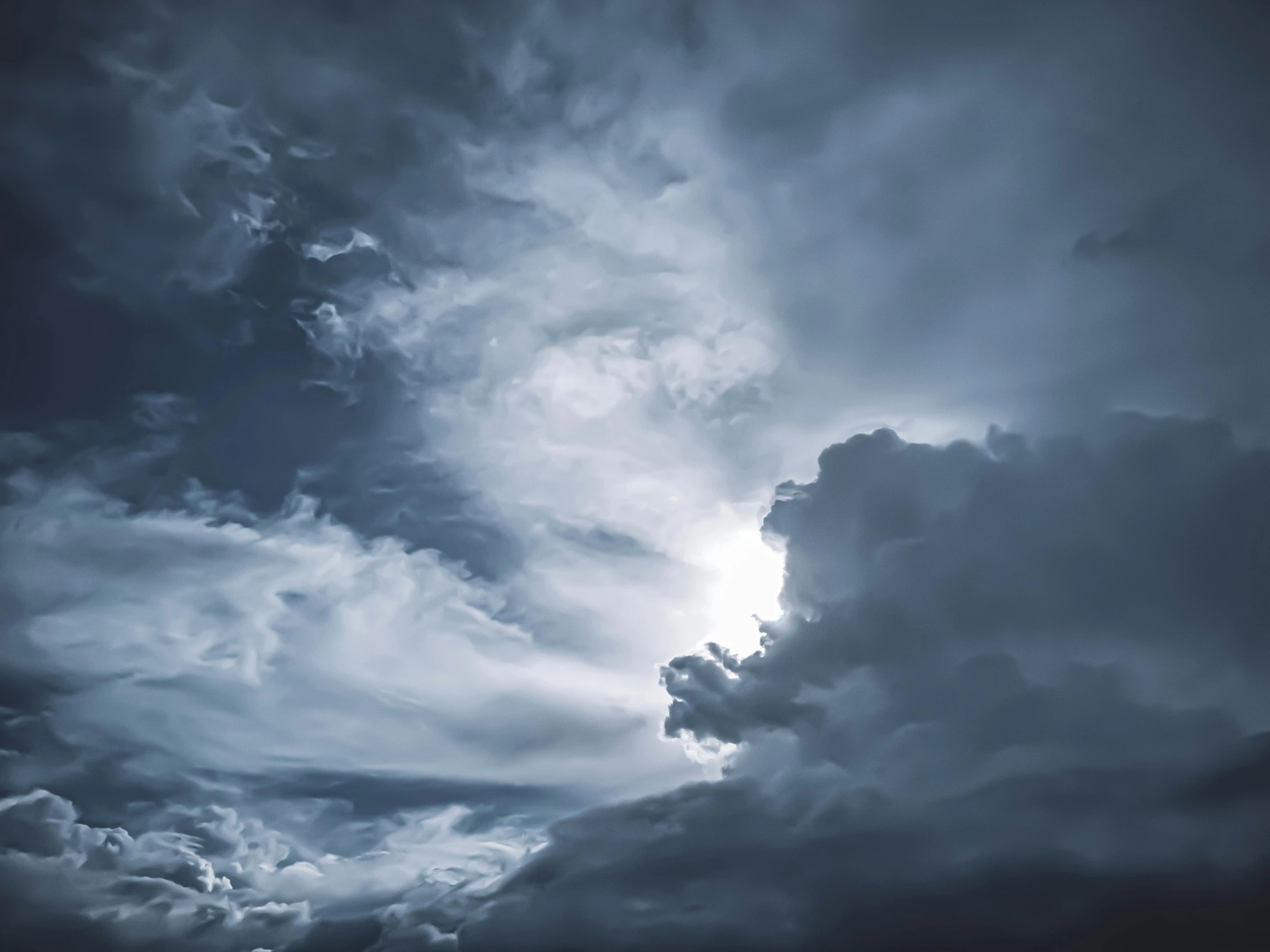 a black and white photo of a cloudy sky, an album cover, by Adam Marczyński, pexels contest winner, romanticism, blue storm clouds, volumetric light clouds, ☁🌪🌙👩🏾, turbulent storm clouds