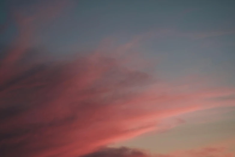 there is a plane that is flying in the sky, by Carey Morris, pexels contest winner, aestheticism, soft light 4 k in pink, red cloud light, a still of an ethereal, light red and deep blue mood