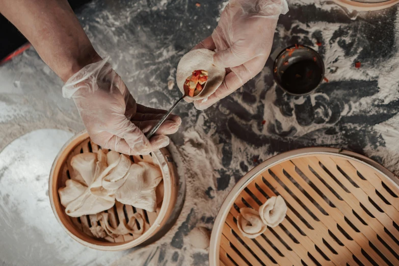 a close up of a person holding a plate of food, steamed buns, straining, offering a plate of food, paisley