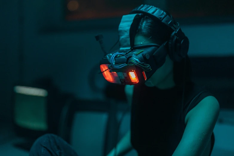 a woman wearing a virtual reality headset in a dark room, inspired by Simon Stålenhag, serial art, gaming headset, lit from below with red lighting, radio goggles, instagram post