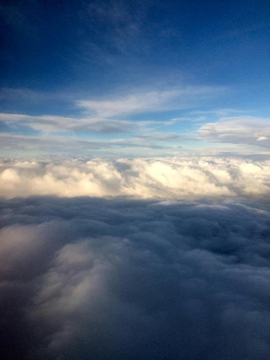 an airplane is flying high above the clouds, by Daniel Taylor, pexels contest winner, hurufiyya, bird\'s eye view, iphone picture, ceremonial clouds, by greg rutkowski