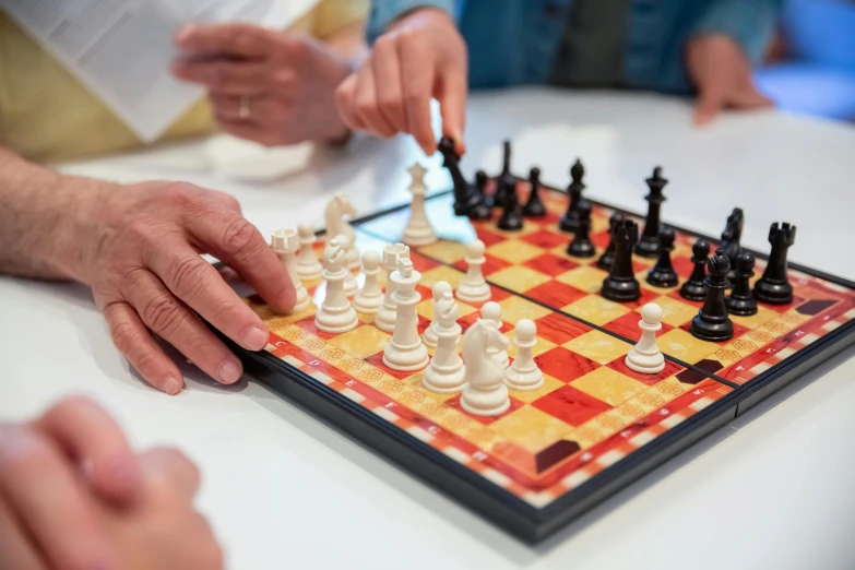 a group of people playing a game of chess, slide show, profile image, zoomed in, 🦩🪐🐞👩🏻🦳