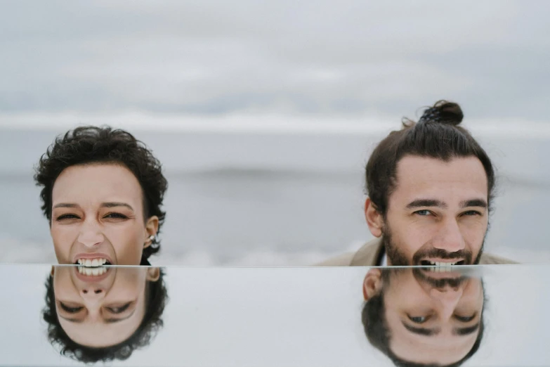 a man and a woman standing in front of a mirror, an album cover, pexels contest winner, antipodeans, half face in the water, smiling :: attractive, groomed facial hair, rafał olbinsk and salvador dali