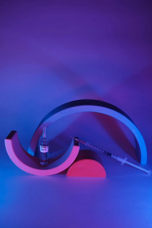 a pair of headphones sitting on top of a table, an abstract sculpture, by Doug Ohlson, kinetic art, holding syringe, ultraviolet and neon colors, curved sword, photographed for reuters