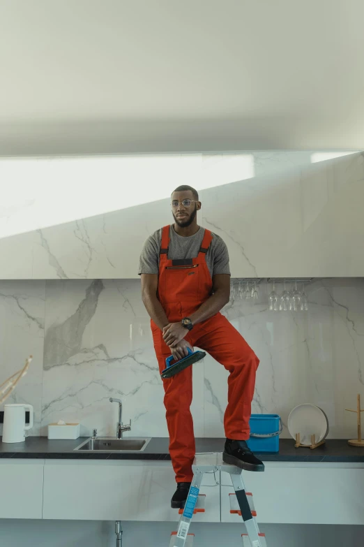 a man sitting on a ladder in a kitchen, virgil abloh, worksafe. cinematic, standing water, full body hero