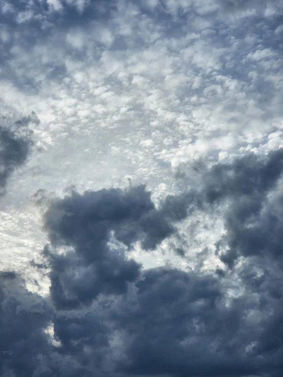 a large jetliner flying through a cloudy sky, an album cover, by Linda Sutton, unsplash, romanticism, ☁🌪🌙👩🏾, layered stratocumulus clouds, today\'s featured photograph 4k, creepy skies