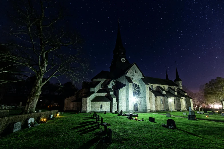 a church lit up at night with the moon in the sky, an album cover, by Jesper Knudsen, pexels contest winner, sounds in the graveyard, wide angle view, a cozy, starry