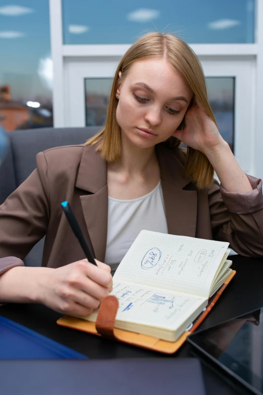 a woman sitting at a desk with a notebook and pen, multiple stories, thumbnail, russian academic, abcdefghijklmnopqrstuvwxyz