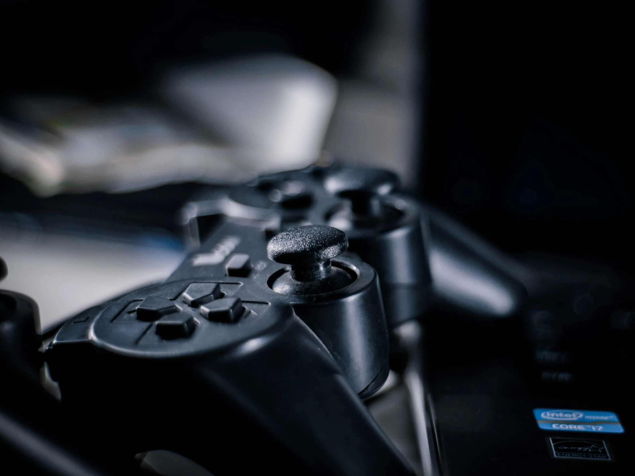 a couple of video game controllers sitting next to each other, unsplash, instagram post, close up photograph, playstation 3, pc screen image