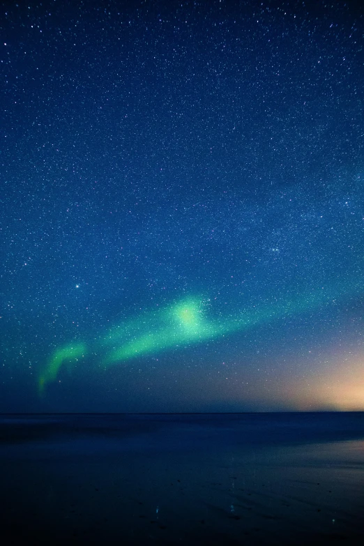 a large body of water under a sky filled with stars, aurora aksnes, waves of lights, star walk, blue sky