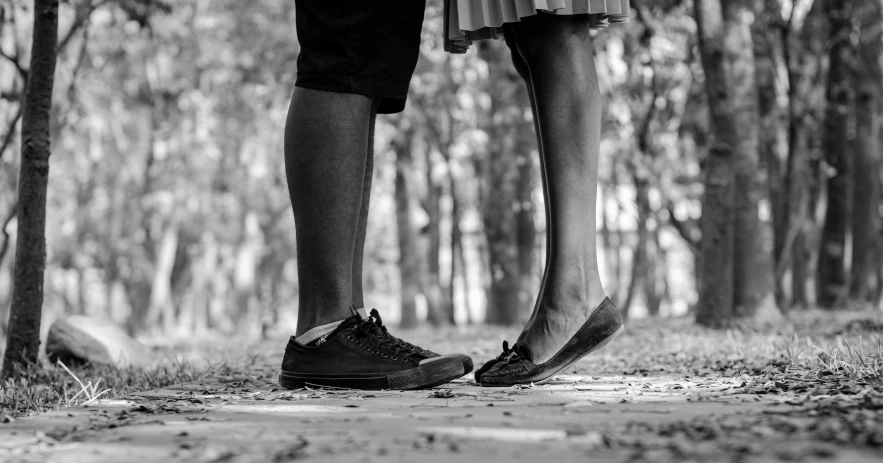 a black and white photo of two people standing next to each other, by Joze Ciuha, pexels, realism, barefeet, in front of a forest background, romantic couple, 15081959 21121991 01012000 4k