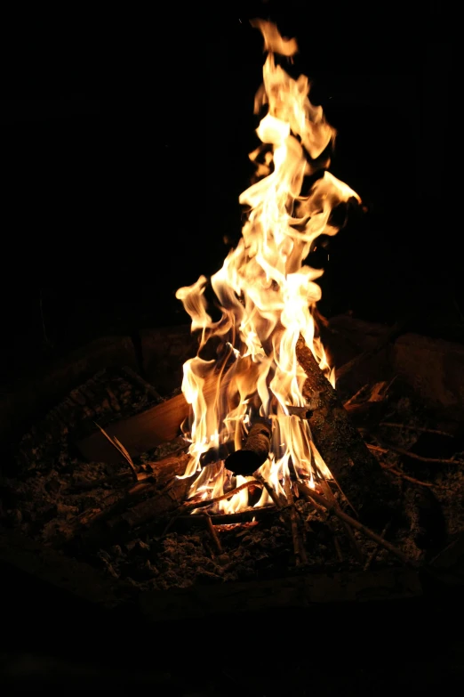 a fire is lit up in the dark, illuminated features, middle of the day, night time lighting, sitting down