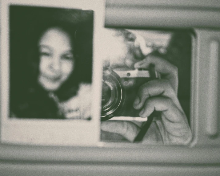 a person taking a picture of themselves in a mirror, a black and white photo, inspired by Diane Arbus, pexels contest winner, a photo of an old opened camera, anime style mixed with fujifilm, smiling into the camera, vintage soft grainy