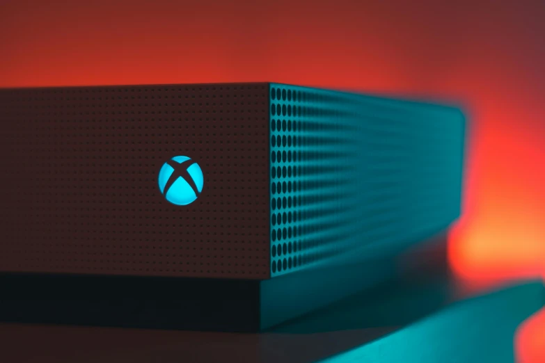 a video game console sitting on top of a table, a digital rendering, by Meredith Dillman, pexels contest winner, cortana, red and cinematic lighting, x - box, closeup portrait shot