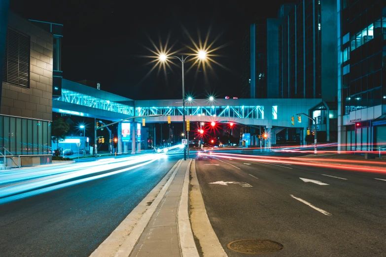 a city street filled with lots of traffic at night, pexels contest winner, overpass, the city of toronto, thumbnail, cyan headlights