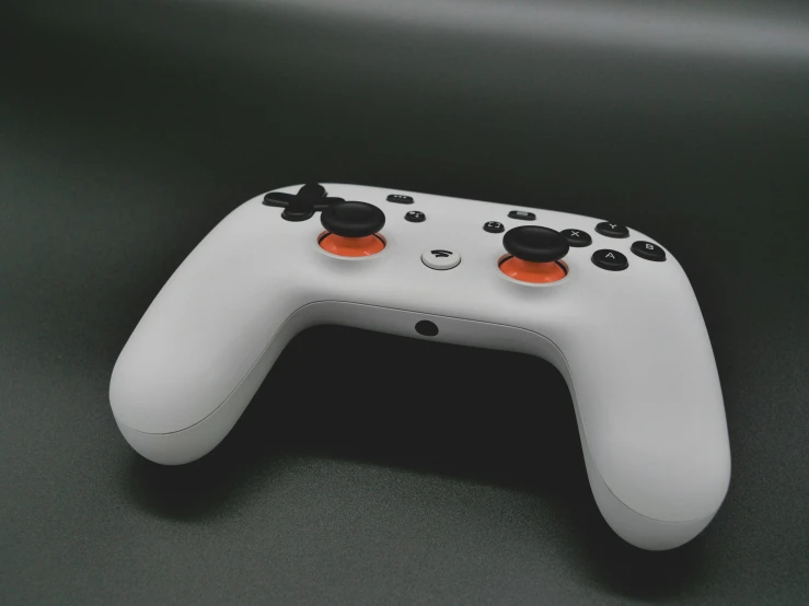 a close up of a controller on a table, an ambient occlusion render, by Carey Morris, unsplash, bauhaus, grey orange, google point of view, front cover of a new video game, on a gray background