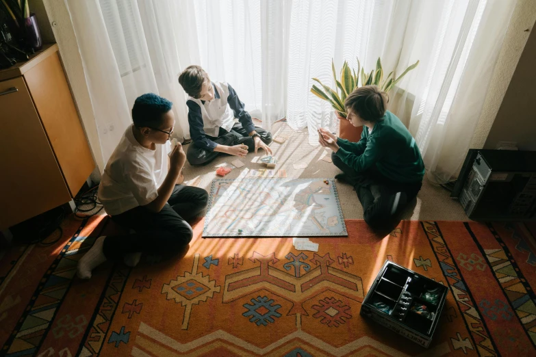 a group of people sitting around in front of a window