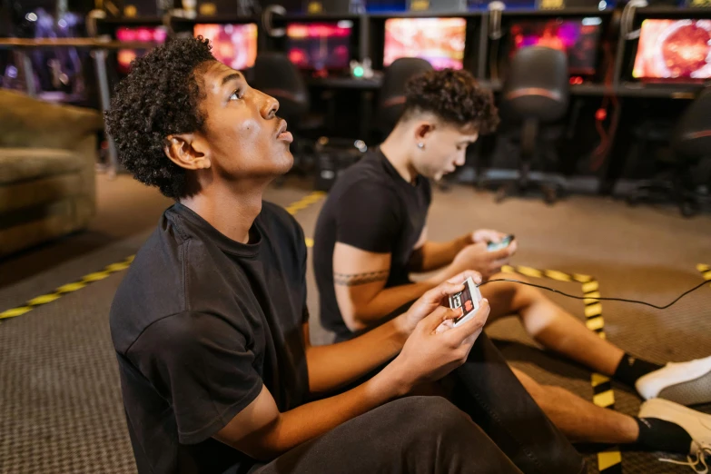 two young men sitting on the floor playing video games, trending on pexels, in a planet fitness, avatar image, uk, headshot