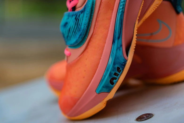 a close up of a pair of shoes on a table, by Aya Goda, unsplash, pink and teal and orange, shot on sony a 7 iii, high-body detail, miami heat colors
