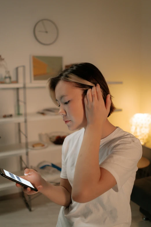 a woman holding a cell phone to her ear, a cartoon, trending on pexels, studyng in bedroom, poor lighting, brain computer interface, low quality photo