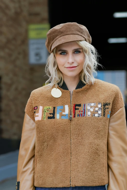 a woman wearing a brown jacket and hat, teddy fresh, cara delevigne, portrait of kim wexler, round-cropped