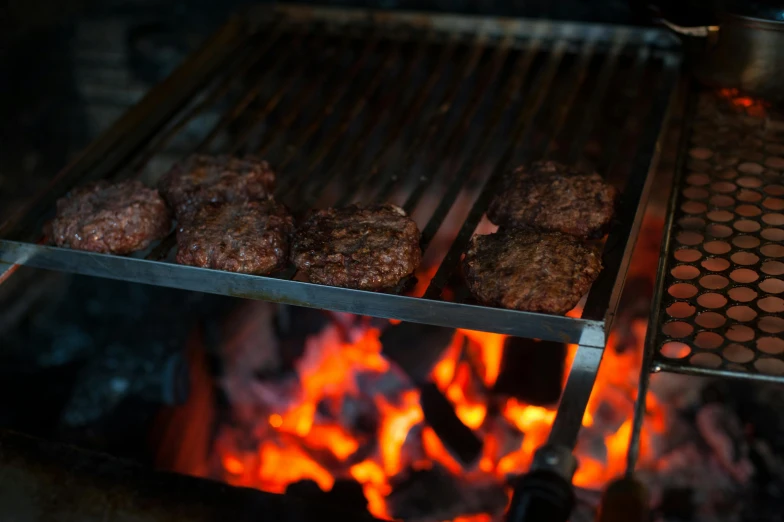 hamburgers cooking on a grill over an open fire, by Joe Bowler, pexels, multiple stories, high detailed photo, pbr, close up portrait shot