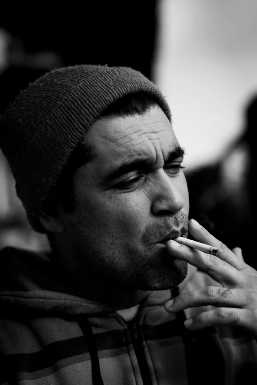 a black and white photo of a man smoking a cigarette, reddit, hyperrealism, zachary quinto, rapper, ((portrait)), atmosphere