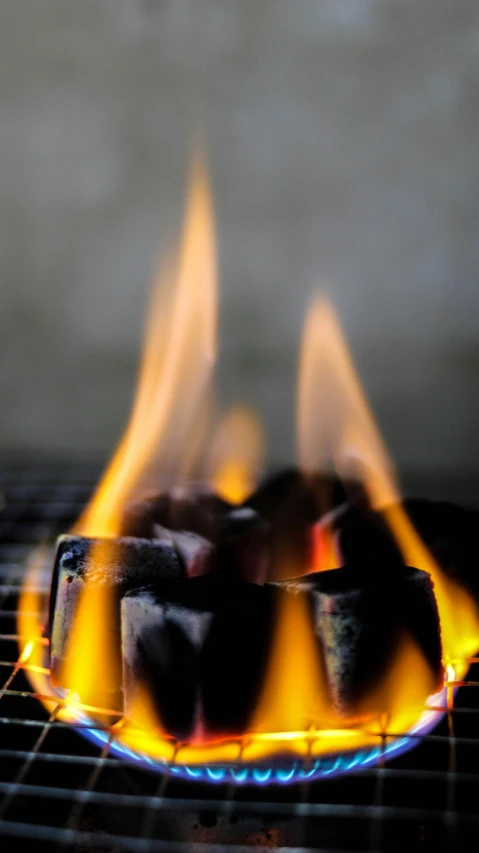 a close up of a grill with flames on it, by John Murdoch, winning photograph, slate, grey, environmental shot