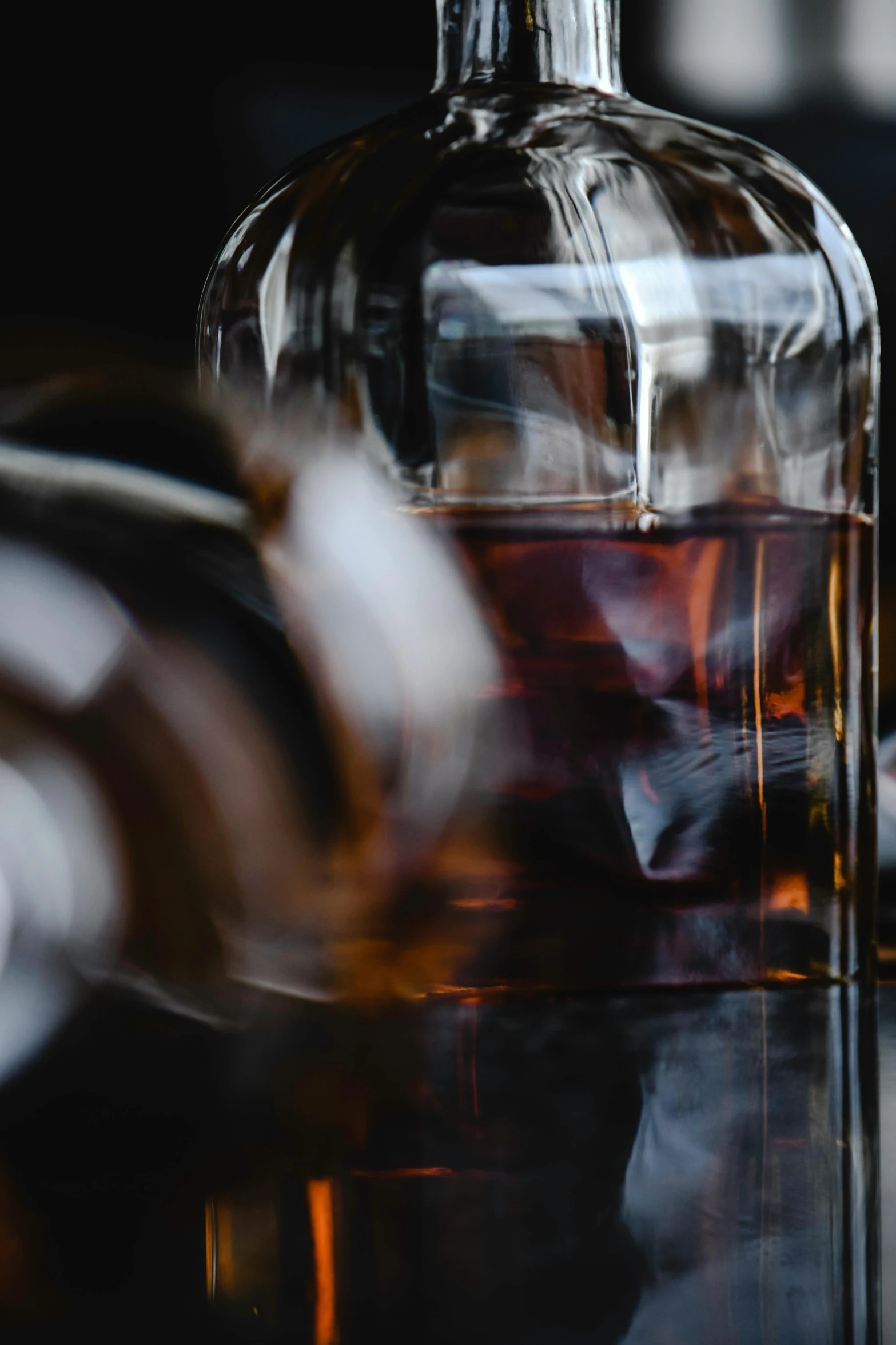 a bottle of whiskey sitting on top of a table, by Adam Marczyński, pexels contest winner, renaissance, detail shot, multi-dimensional, black, zoomed in