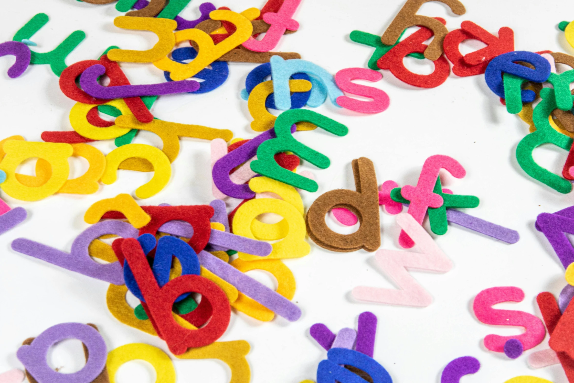 a pile of felt letters sitting on top of a table, detailed product image, full product shot, abcdefghijklmnopqrstuvwxyz, hair loops