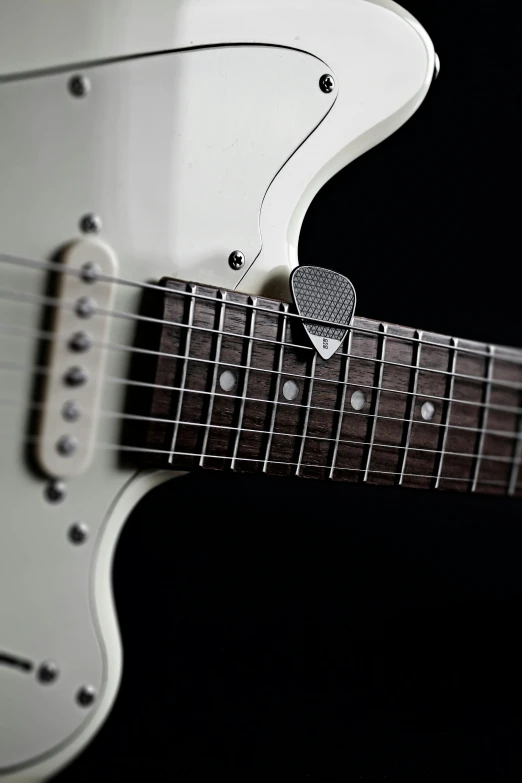 a close up of a white electric guitar, in gunmetal grey, environmental shot, fujifilm”, micro detail