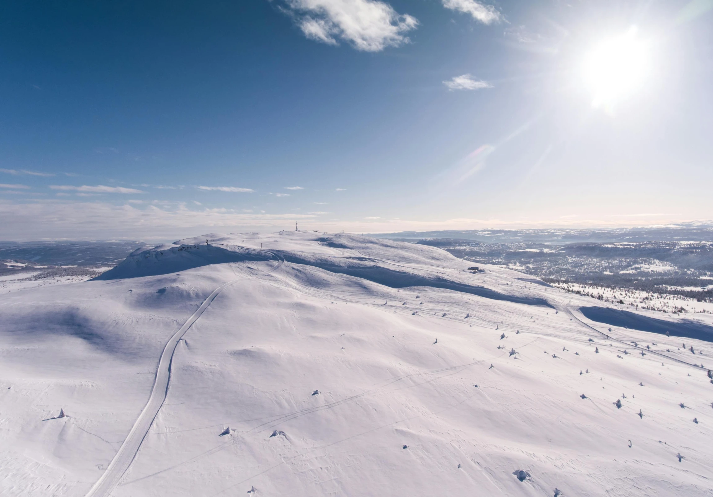 a man riding a snowboard down the side of a snow covered slope, by Anton Lehmden, pexels contest winner, hurufiyya, “ aerial view of a mountain, lapland, obsidian towers in the distance, ground covered with snow