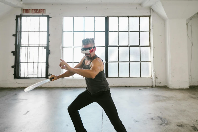 a man holding a large knife in a room, a hologram, unsplash, interactive art, wearing bandit mask, combat goggles, practising sword stances, avatar image