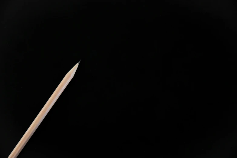 a close up of a pencil with a black background, by Adam Chmielowski, centred in image, 2 0 0 0's photo, open negative space, 120 degree view