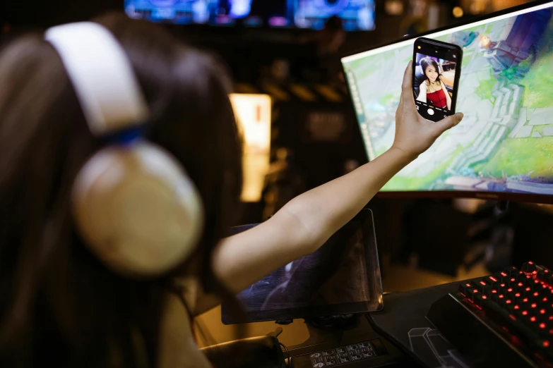 a woman is playing a video game on her phone, a picture, trending on pexels, avatar image, air shot, server in the middle, professional photo