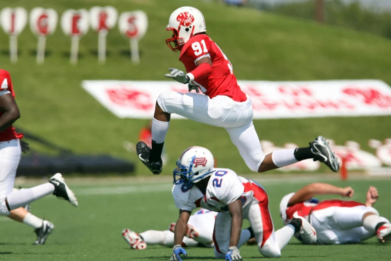 a group of young men playing a game of football, a digital rendering, flickr, happening, ultra - high jump, red and white color scheme, air is being pushed around him, alexis franklin