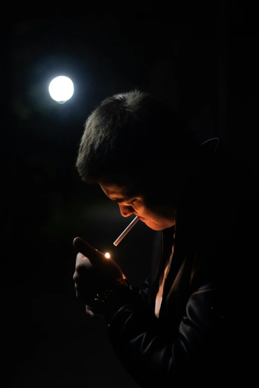 a man smoking a cigarette in the dark, looking at the moon, ap news, high school, lights off