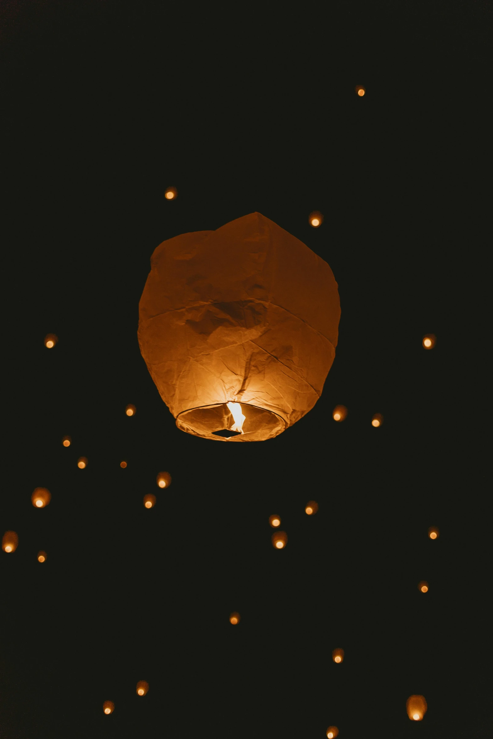 a sky lantern flying through the night sky, an album cover, pexels contest winner, light and space, tea drinking and paper lanterns, light tan, profile image, floats in space