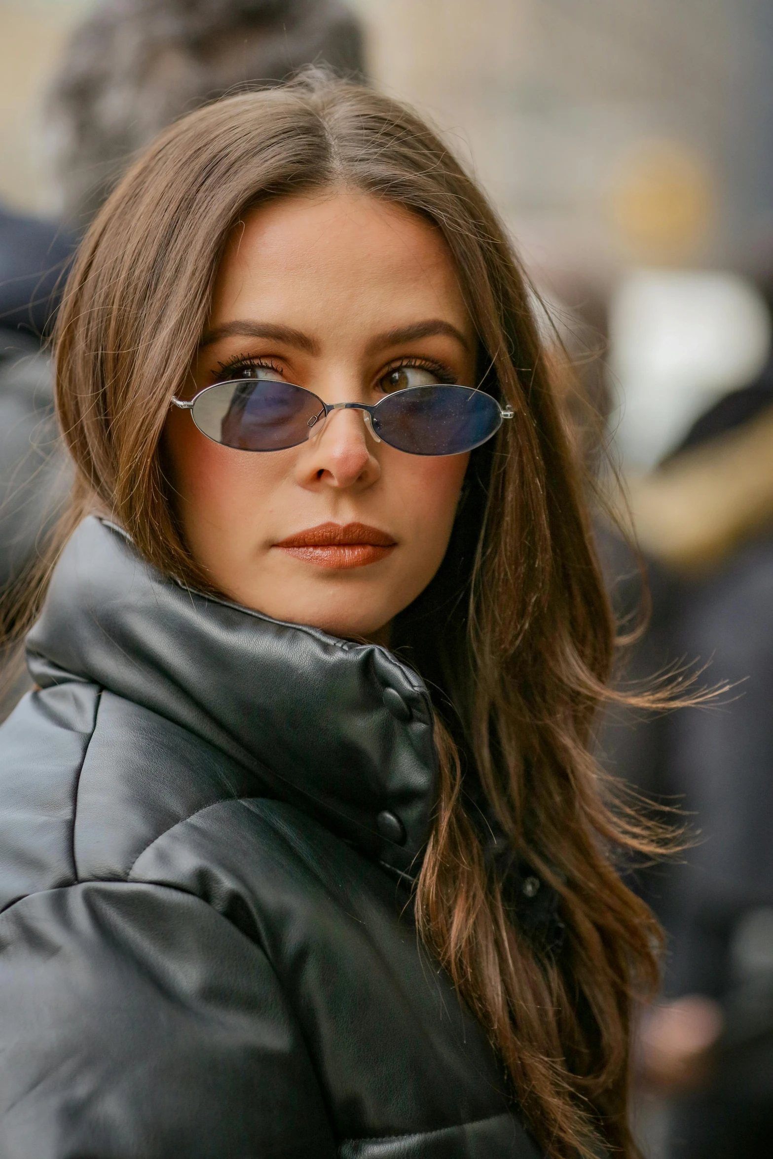 a close up of a person wearing a jacket and sunglasses, a colorized photo, inspired by Anita Malfatti, trending on pexels, portrait sophie mudd, street life, oval shaped face, kaya scodelario