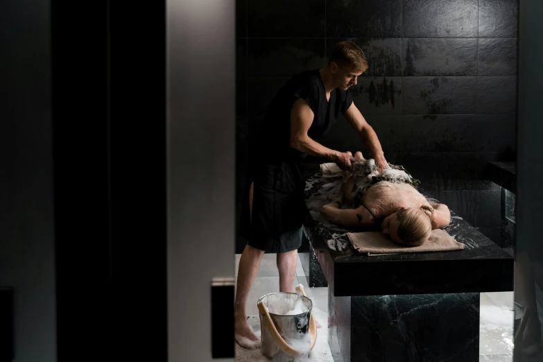 a woman is shaving a man in a bathroom, by Emma Andijewska, massurrealism, man carving himself out of stone, wētā fx, luxurious environment, grey