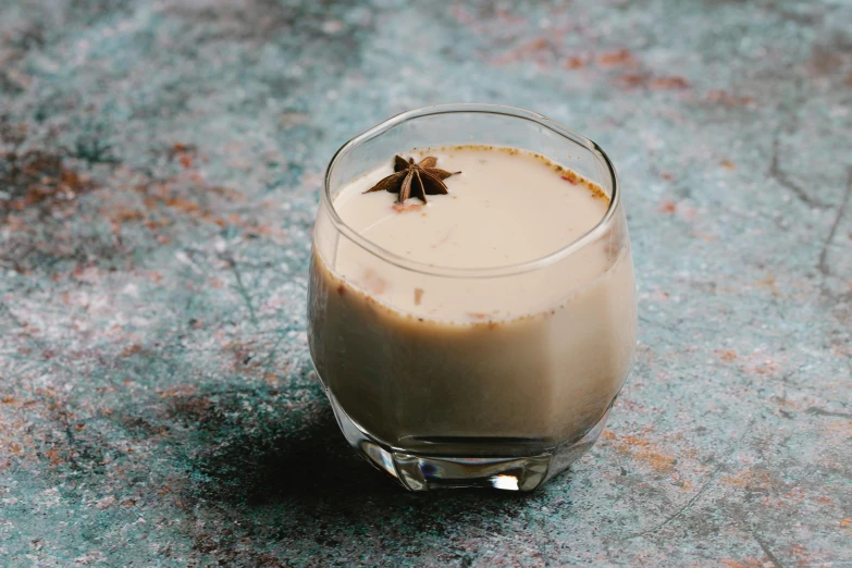 a close up of a drink in a glass on a table, soey milk, profile image, thumbnail, caramel