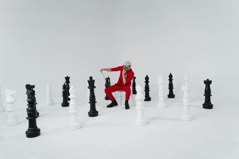 a man in a red suit playing a game of chess, inspired by Horace Vernet, pexels contest winner, video art, die antwoord yolandi visser, full body photoshoot, dua lipa, various poses shooting photos