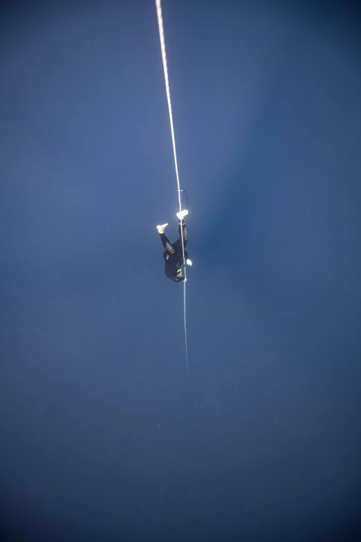 a man flying through the air while holding onto a parachute, by Paul Bird, rasquache, attached to wires. dark, top secret space plane, photograph taken in 2 0 2 0, minn