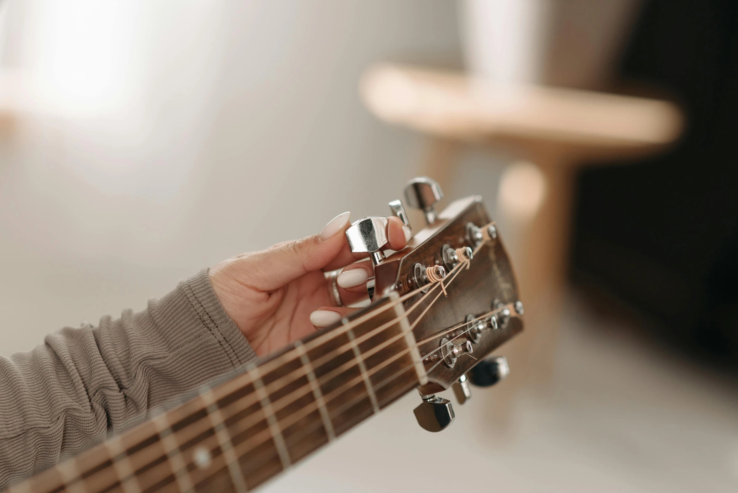 a close up of a person playing a guitar, on a white table, linsey levendall, perfectly shaded, easy to use