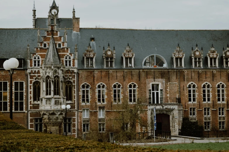 a large brick building with a clock tower, by Villard de Honnecourt, pexels contest winner, renaissance, palace of the chalice, thumbnail, cinematic image, outside the'school of magic '