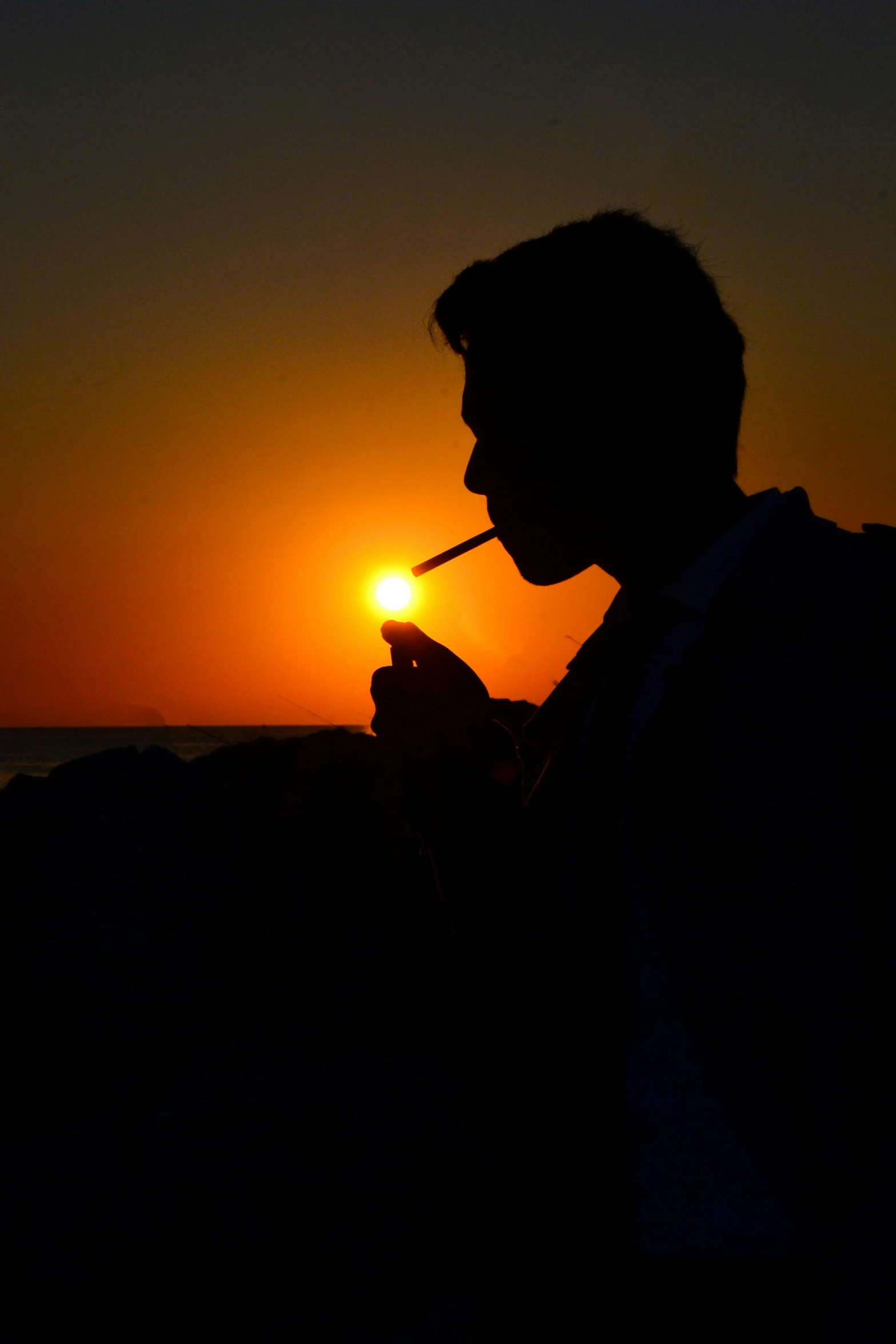 a man smoking a cigarette with the sun setting in the background, by Alexis Grimou, ((sunset)), lightbox, suns, silhouette :7