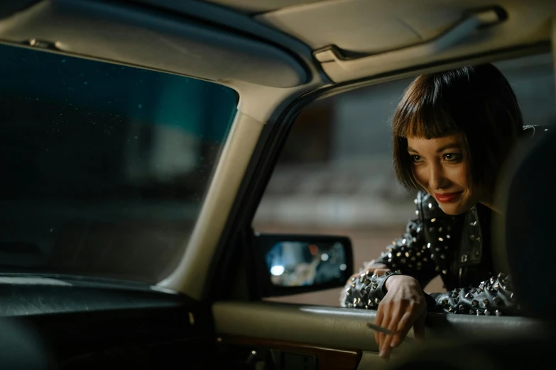 a woman sitting in a car looking out the window, inspired by Elsa Bleda, trending on pexels, photorealism, kiko mizuhara, with dramatic lighting, cinematic outfit photo, gemma chan