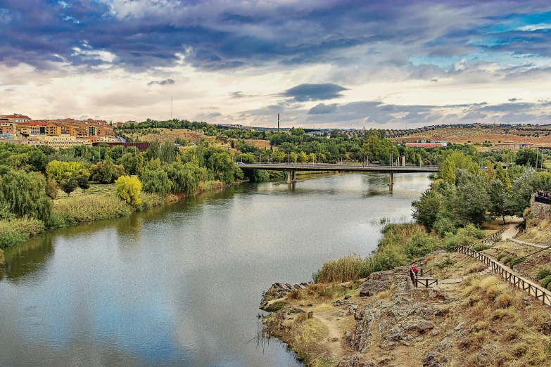 a river running through a lush green countryside, pexels contest winner, teruel city in 1989, panorama, fan favorite, red river